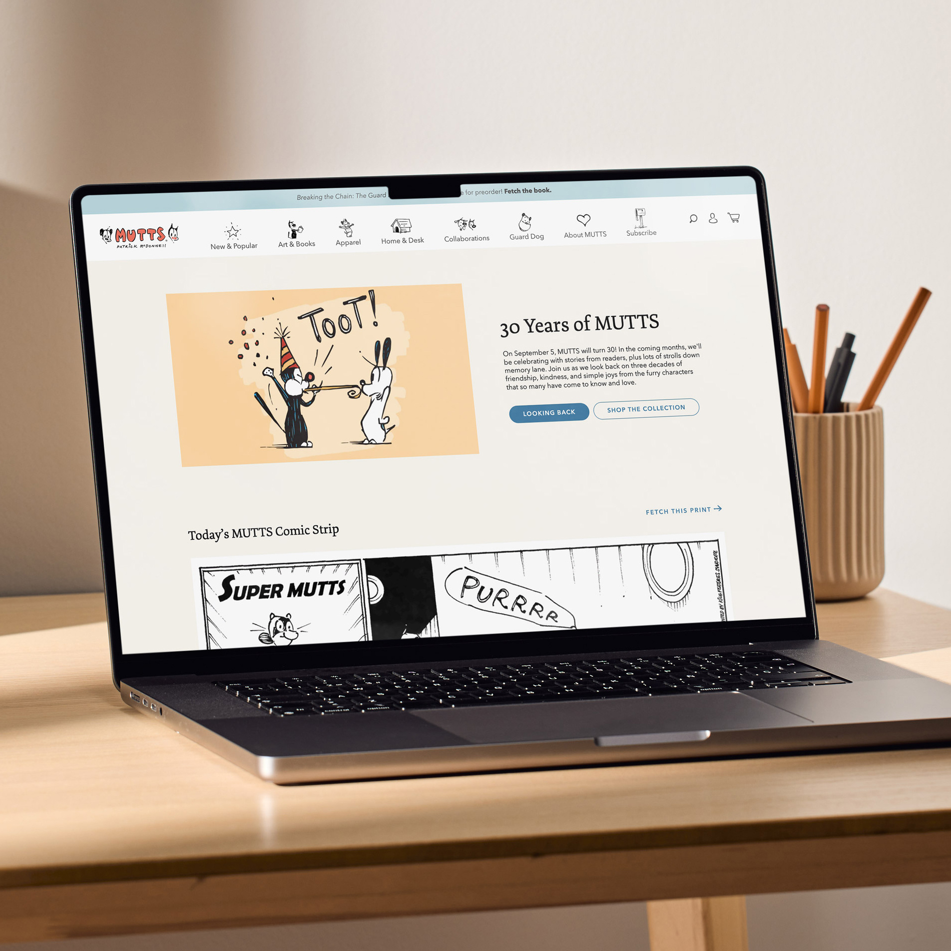 Laptop sitting on a desk showing the MUTTS Comics website